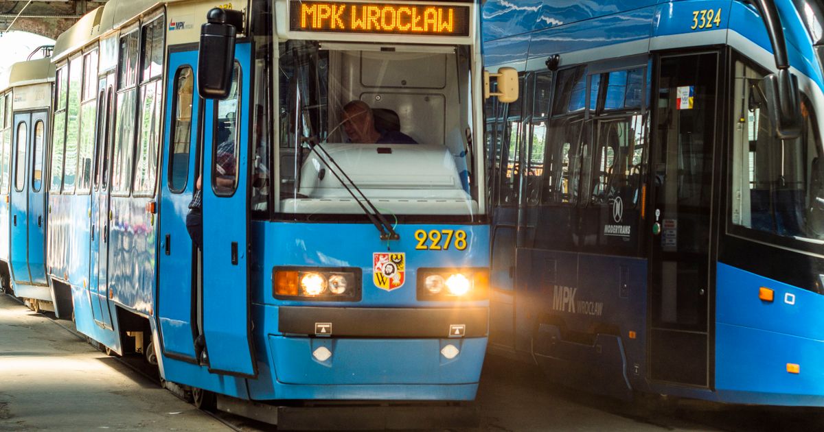 Blue trams at MPK Wroclaw station indoors, showcasing urban transport.