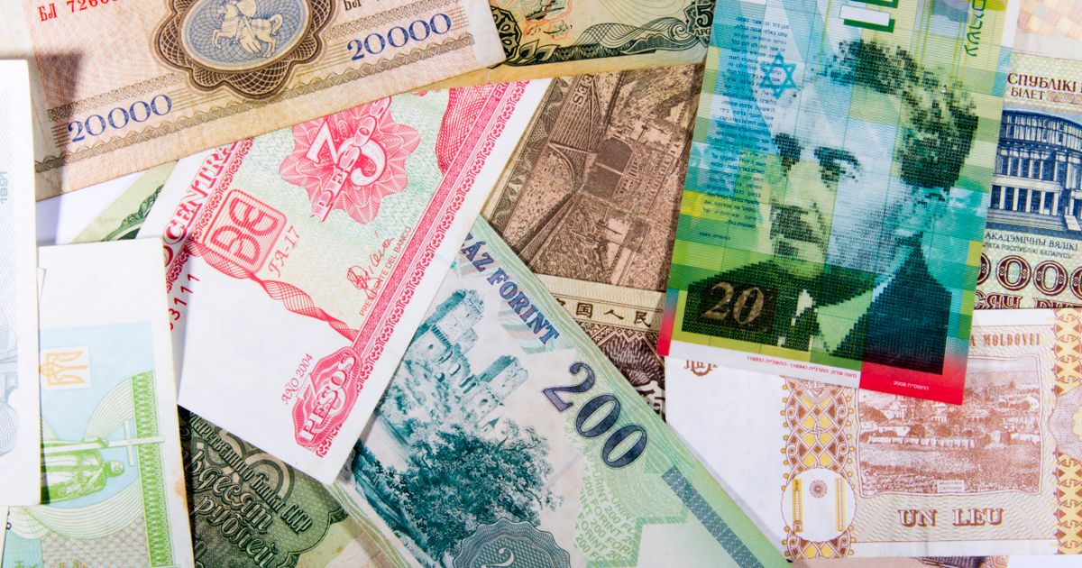 Colorful assortment of international paper currencies from various countries in a flat lay.