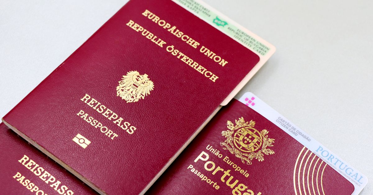 A close-up image of Austrian and Portuguese passports with a Bulgarian ID card.